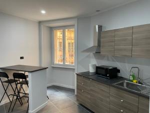 a kitchen with a sink and a counter top at This must be the place Rome Guesthouse in Rome
