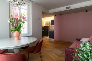 a living room with a table and a couch at ALMA Apartment in Alba