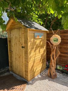 a wooden out house next to a tree at Sougia Glamping in Chania