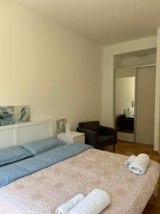 a bedroom with a large bed and a living room at Pool and spa apartment 1BR in Donji Morinj