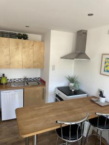 a kitchen with a wooden table and some chairs at Immaculate 2-Bed Lodge in Hayle in Hayle