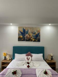 a bedroom with a bed with two flowers on it at Apartmani Pranić in Mostar