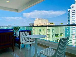 einen Tisch und Stühle auf einem Balkon mit Aussicht in der Unterkunft Wonderful 2BR with impressive view in Cartagena de Indias