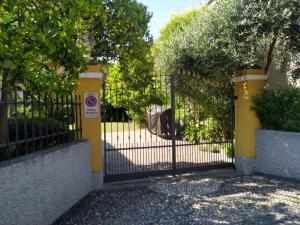 a black gate with a sign in front of it at Andoramare B&B in Marina dʼAndora