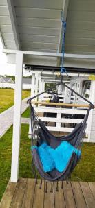 a hammock is hanging from a porch at Domki Martes Wicie in Wicie