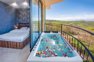 a room with a tub with stuffed animals in it at Villaggio Mirzaani Resort in Sighnaghi