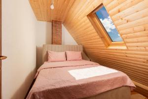 a bedroom with a bed and a window in a room at Lake house Sreten in Šavnik