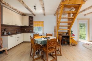 a kitchen with a table and chairs and a ladder at Lake house Sreten in Šavnik +7 photos