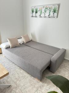 a bed with two pillows on it in a room at Cabildo 3 in Sanlúcar de Barrameda