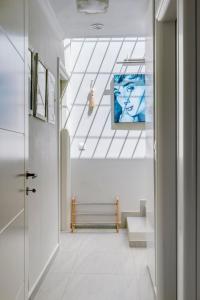 a hallway with a staircase with a painting on the ceiling at Villa Marenosta in Ermoupoli