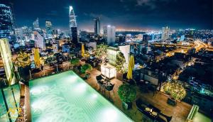 a swimming pool on top of a building with a city skyline at The Rixx Ben Thanh Tower - The One Saigon in Ho Chi Minh City