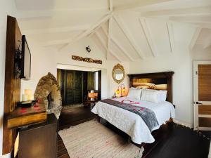 - une chambre avec un grand lit et un miroir dans l'établissement Hotel & Spa - Caney campestre Villa de Leiva by MH, à Villa de Leyva