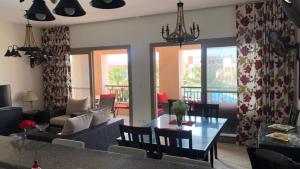 a living room with a couch and a table at Chalet Verdi Marassi view lagoon in El Alamein