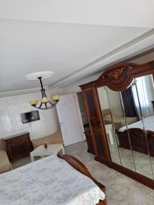 1 dormitorio con cama y espejo grande en NINO, en Kobuleti