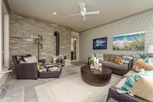 a living room with furniture and a brick wall at Private Pool & Lake MI access, hot tub, putting green, basketball court, and more! in Fennville