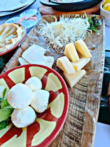 a plate of cheese and other foods on a cutting board at Dana star in Dana
