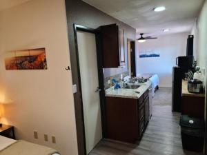 a room with a kitchen with a sink and a bed at 070B Grand Canyon Suite with Kitchenette near South Rim Sleeps 4 in Valle