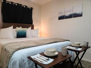 a hotel room with a bed with two tables at 070B Cozy Studio with Kitchen nr South Rim Sleeps 4 in Valle