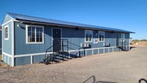 a blue building with stairs in a parking lot at 070B Cozy Studio with Kitchen nr South Rim Sleeps 4 in Valle