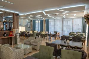 a restaurant with tables and chairs and windows at Premium Berlin with Pool in Ulcinj