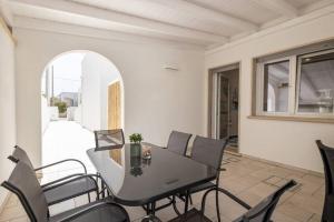 a dining room with a table and chairs at Belvedere Apartments A in Marina di Mancaversa +20 photos