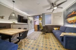 a living room with a blue couch and a table at City CENTRAL Apartment Romantic Lakefront Balcony - MALCESINE - Porto Vecchio 11 in Malcesine