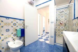 a bathroom with a toilet and a sink and a shower at Belvedere Apartments A in Marina di Mancaversa