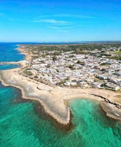 an aerial view of a beach with houses and the ocean at Belvedere Apartments A in Marina di Mancaversa