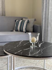 a black marble coffee table in a living room with a couch at Stellar Dreams in Kavala