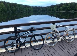 a bike parked on a pier next to a lake at Apartament nad jeziorem Ukiel in Olsztyn