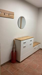 a room with a dresser and a mirror on the wall at Freshly renovated Studio apartment - top location in Weinstadt in Weinstadt