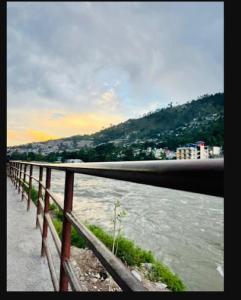 a fence next to a body of water at River Vibes Guest House in Muzaffarabad +13 photos