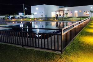 a row of swimming pools at night at Casa Aconchegante B in Guanamby