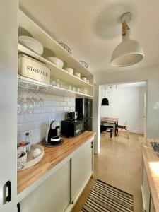 a kitchen with white cabinets and a counter at Puerta Azul in Punta del Este