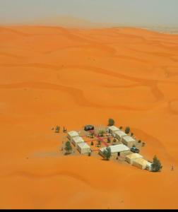 an aerial view of a camp in the desert at Camel Trips Luxury Camp in Merzouga