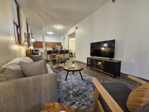 a living room with a couch and a flat screen tv at City Hall Clerk's Office in Rochester