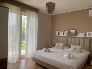 a bedroom with a bed with two stuffed animals on it at Taormina Rooms Panoramic Apartments in Taormina