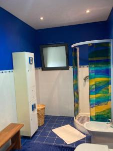 a bathroom with a shower and a sink at Quinta de Santana - Queimadas in Furnas