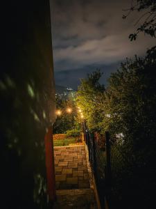 a walkway at night with lights on at Apartment Benjo in Sarajevo