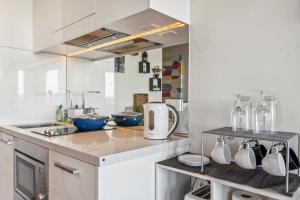 a kitchen with a counter with bowls and appliances at Beachfront Studio Apartment in Frankston Melbourne in Frankston