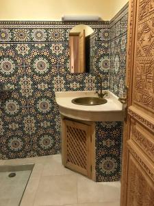 La salle de bains est pourvue d'un lavabo et d'un miroir. dans l'établissement Flottement Des Songes, à Marrakech