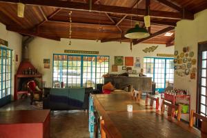 a living room with a table and chairs in a room at Vill Angeli in Gonçalves