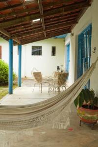 a hammock on a patio with chairs and a table at Vill Angeli in Gonçalves