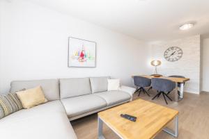 a living room with a white couch and a table at Luxury Apartments Sunny Side in Makarska