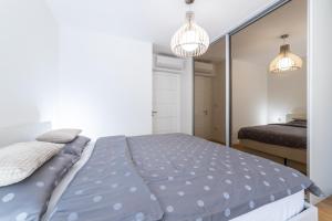 a bedroom with a bed and a mirror at Luxury Apartments Sunny Side in Makarska