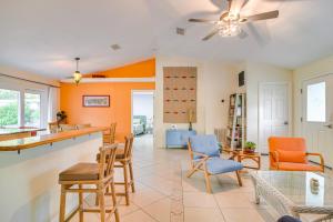 a kitchen and living room with orange and blue chairs at Lovely St Petersburg Home with Backyard Oasis in St. Petersburg