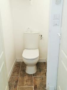 a bathroom with a white toilet in a room at Calanques Prado Stade et Parking in Marseille