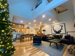 a living room with a christmas tree in it at Ski in Ski out, modern alpine chic in Vail +36 photos