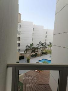 a balcony with a view of a building and a pool at شاليه غرفة ورسيبشن وحمام ومطبخ عماره 6 الدور الثاني 6232 in Port Said