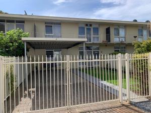 a white fence in front of a house at Sunshine Three in Salisbury